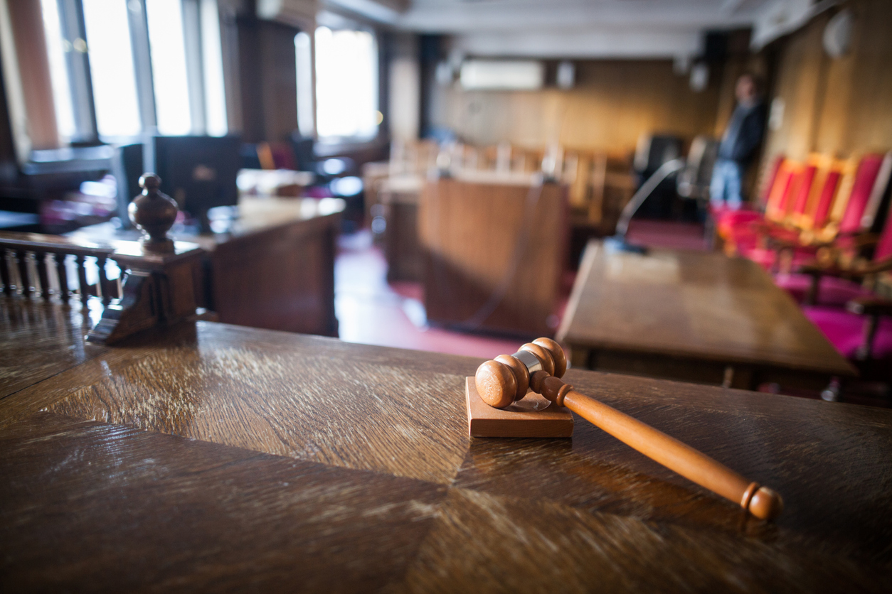 Advocacy image of a hammer in a courtroom.